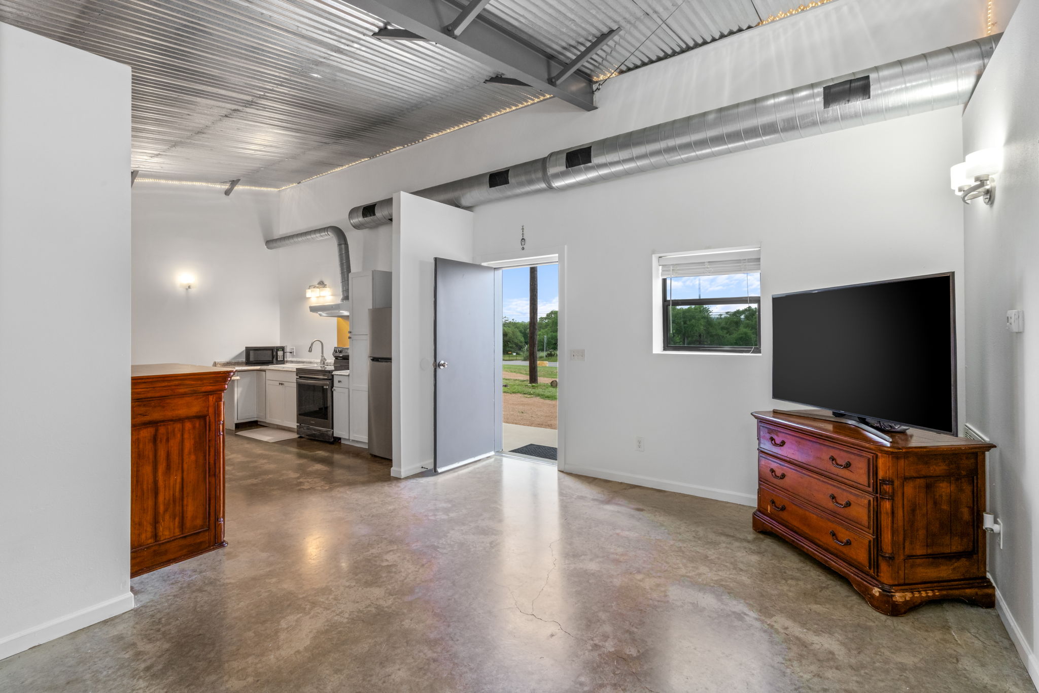 180 Henly Loop Dripping Springs, TX 78620 - Photo 31 of 38 a view of a livingroom with furniture and a flat screen tv