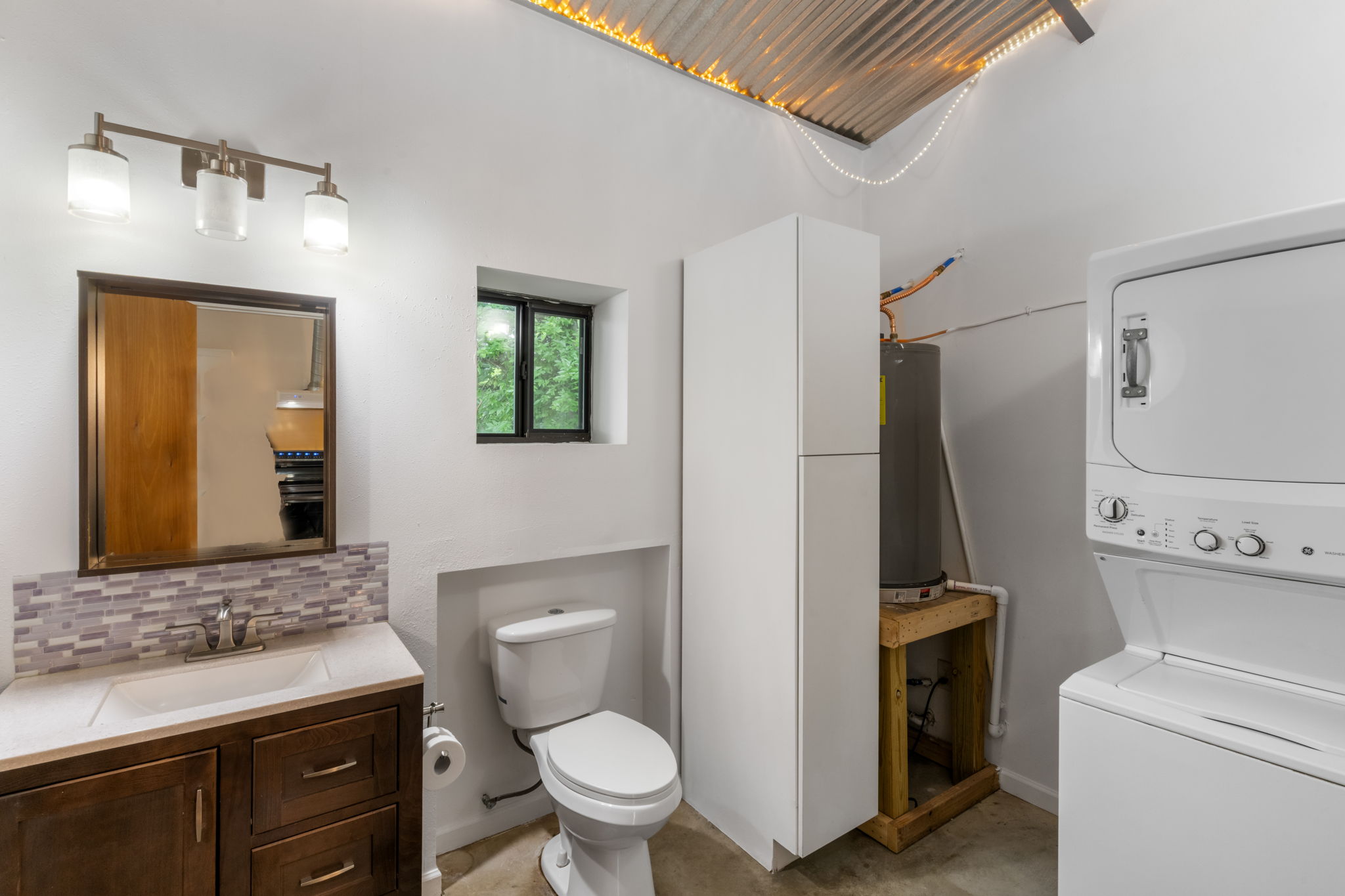 180 Henly Loop Dripping Springs, TX 78620 - Photo 33 of 38 a bathroom with a toilet sink and mirror