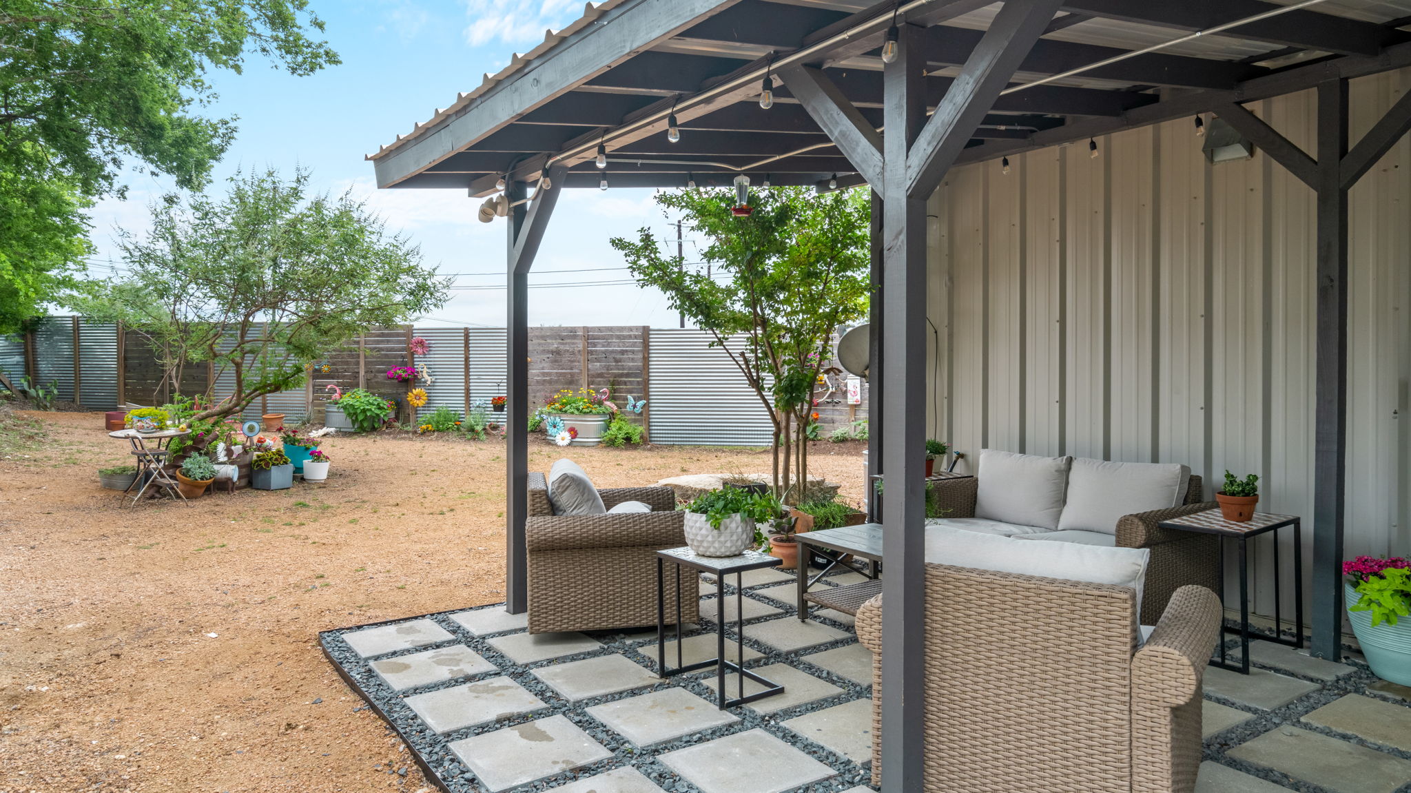 180 Henly Loop Dripping Springs, TX 78620 - Photo 37 of 38 a view of a patio with table and chairs and potted plants