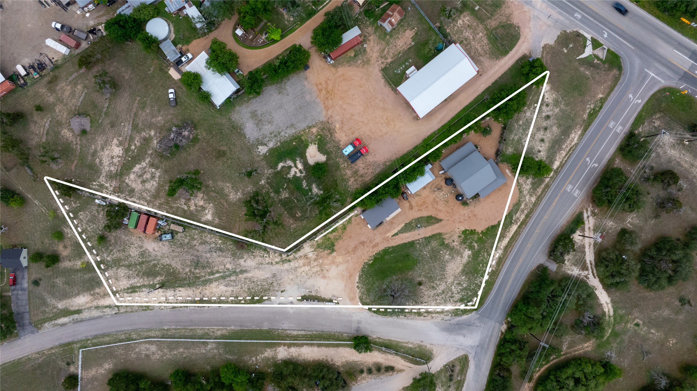180 Henly Loop Dripping Springs, TX 78620 - Photo 6 of 38 an aerial view of a house with a yard