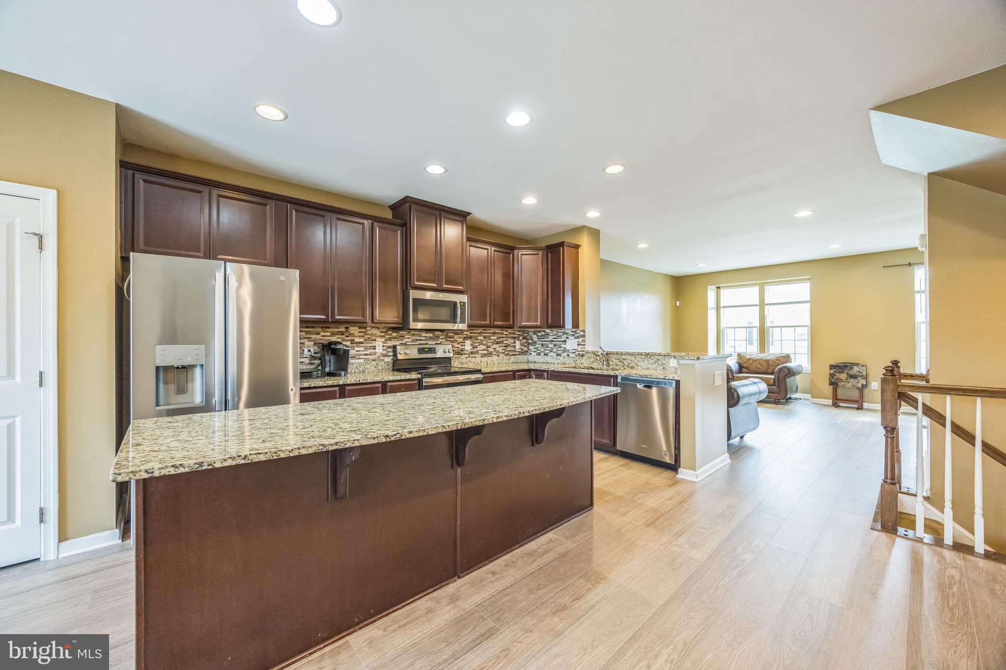 1072 Prime Place Sewell, NJ 08080 - Photo 11 of 36 a large kitchen with stainless steel appliances lots of counter space and wooden floors