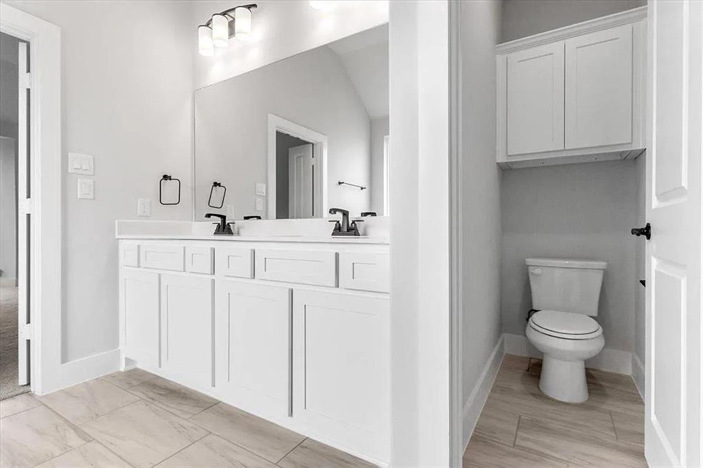 6246 Shasta Creek Road Celina, TX 75009 - Photo 17 of 24 a bathroom with a sink toilet and mirror