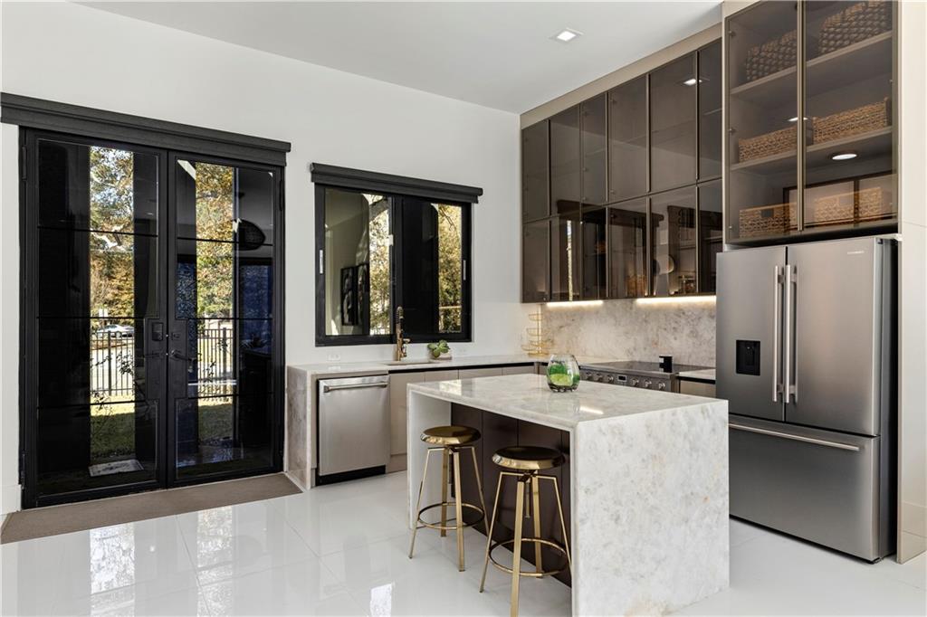 3600 Lower Roswell Road Marietta, GA 30068 - Photo 61 of 83 a kitchen with stainless steel appliances granite countertop a refrigerator and a stove top oven