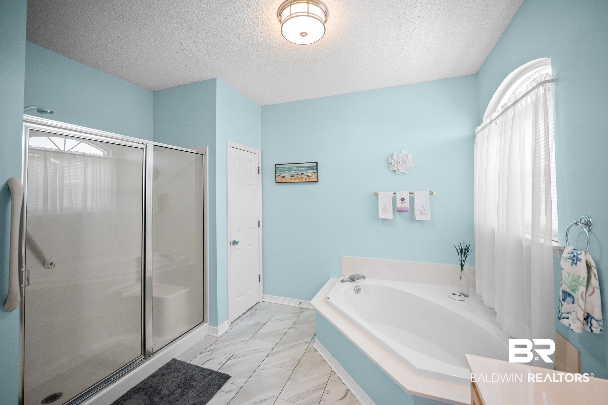 22355 East County Road 12 Foley, AL 36535 - Photo 33 of 54 Bathroom featuring a stall shower, a garden tub, light marble finish floors, and a textured ceiling