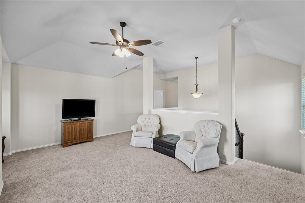 4102 Sublett Way Kaufman, TX 75142 - Photo 22 of 40 Unfurnished room featuring lofted ceiling, carpet floors, ceiling fan, and an upstairs landing