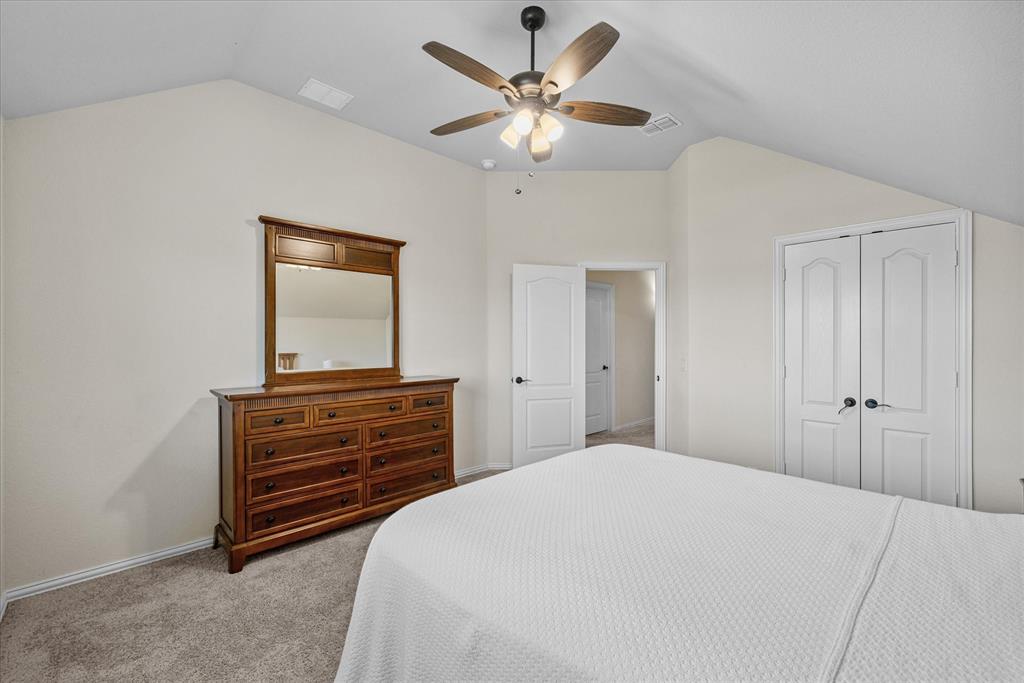 4102 Sublett Way Kaufman, TX 75142 - Photo 26 of 40 Bedroom with lofted ceiling, light colored carpet, a closet, and ceiling fan