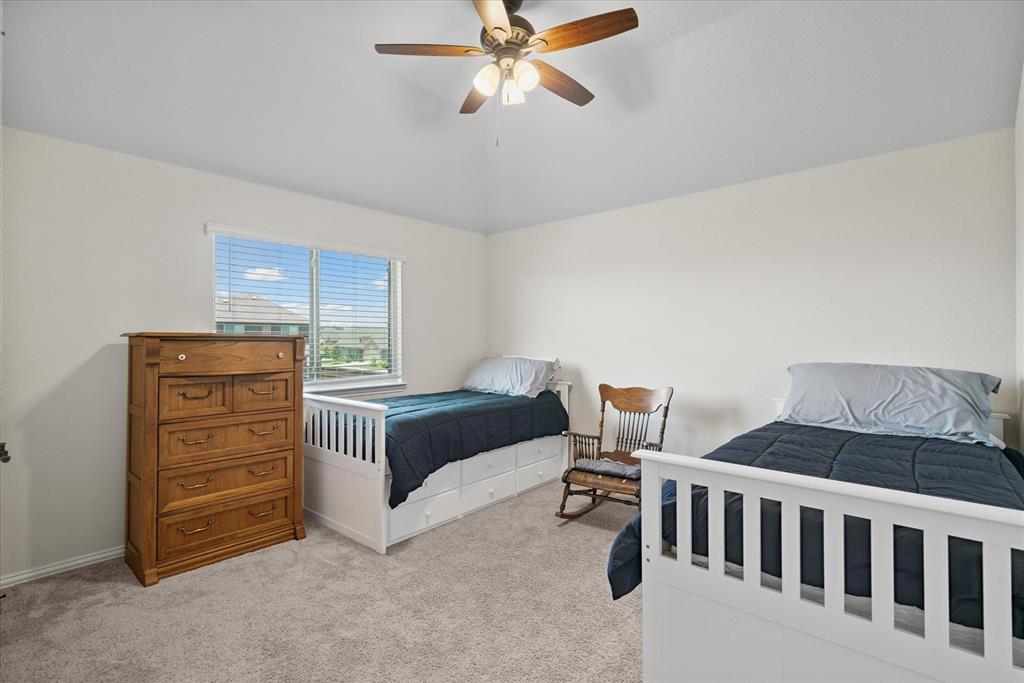 4102 Sublett Way Kaufman, TX 75142 - Photo 27 of 40 Bedroom with light colored carpet, vaulted ceiling, and ceiling fan