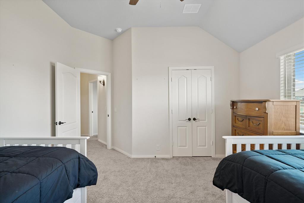 4102 Sublett Way Kaufman, TX 75142 - Photo 28 of 40 Bedroom featuring light colored carpet, a closet, vaulted ceiling, and a ceiling fan