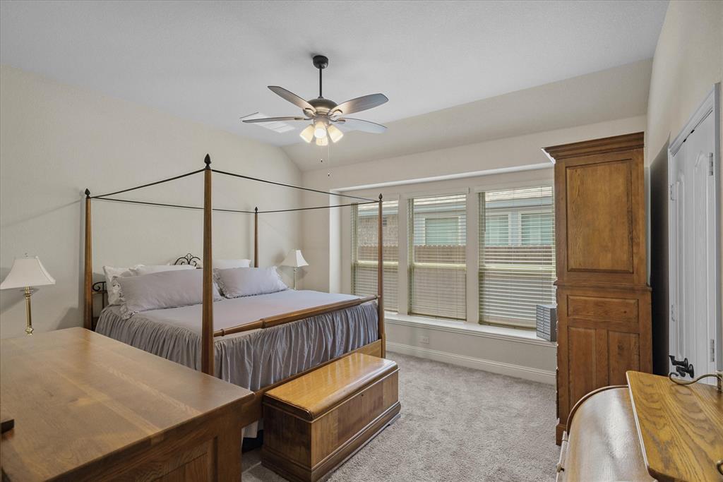 4102 Sublett Way Kaufman, TX 75142 - Photo 30 of 40 Bedroom featuring light colored carpet, vaulted ceiling, and a ceiling fan