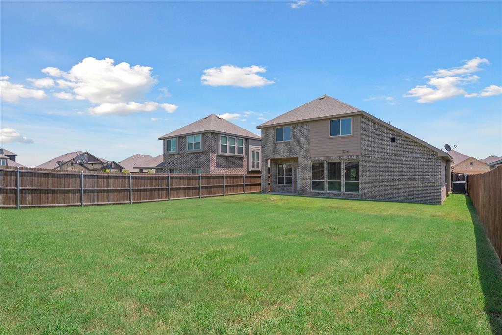 4102 Sublett Way Kaufman, TX 75142 - Photo 39 of 40 Rear view of property with a fenced backyard and brick siding