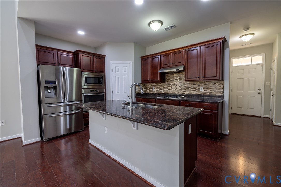 4801 Shellbark Court Glen Allen, VA 23059 - Photo 12 of 43 a kitchen with stainless steel appliances granite countertop a refrigerator a stove and a wooden floors