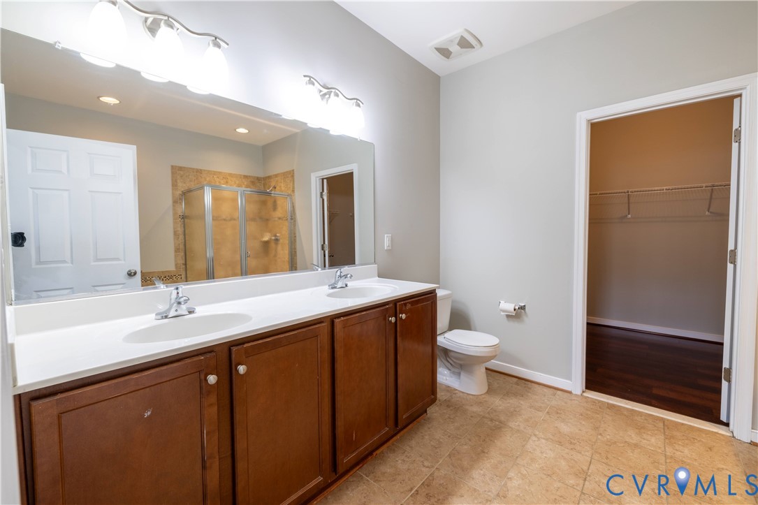 4801 Shellbark Court Glen Allen, VA 23059 - Photo 20 of 43 a bathroom with a double vanity sink toilet and mirror