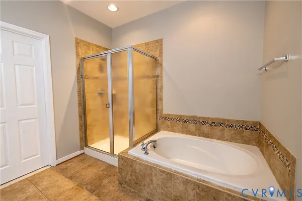 a bathroom with a tub and shower