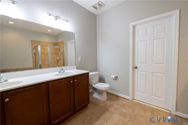 a bathroom with a toilet a sink and mirror