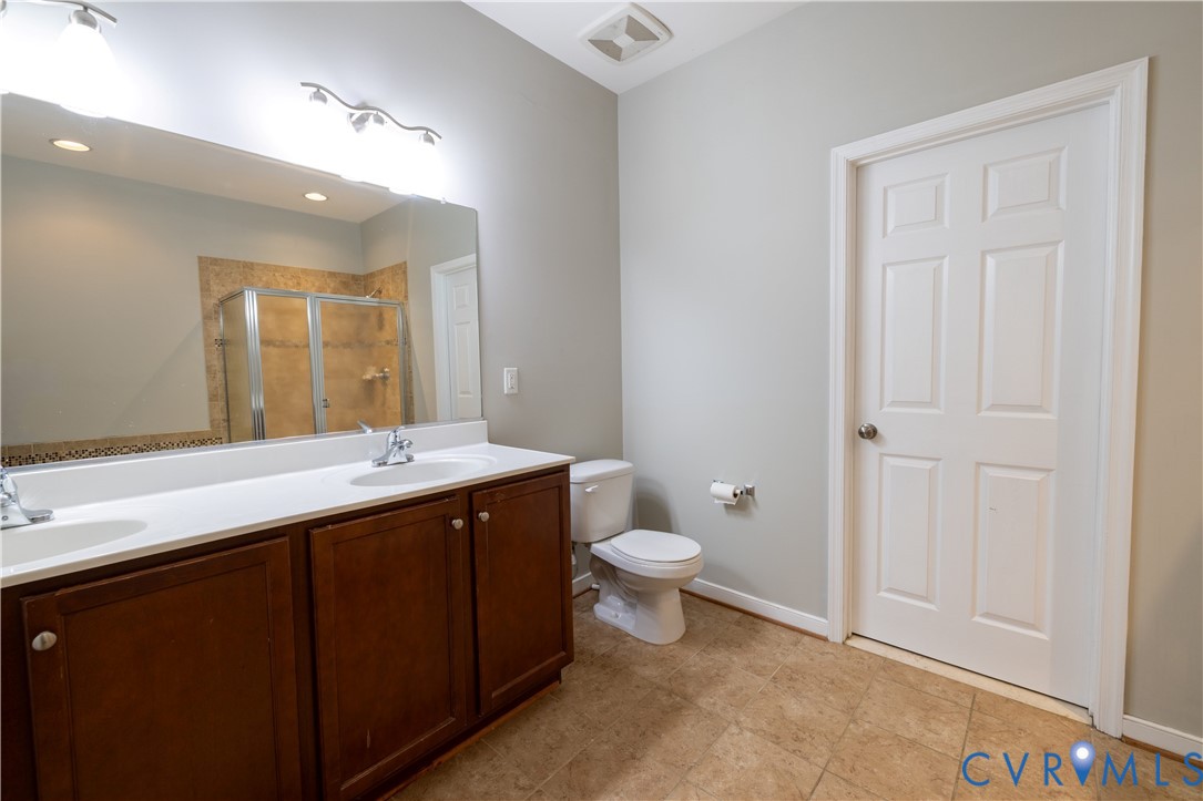 4801 Shellbark Court Glen Allen, VA 23059 - Photo 22 of 43 a bathroom with a toilet a sink and mirror