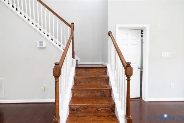 a view of staircase with wooden floor and a potted plant