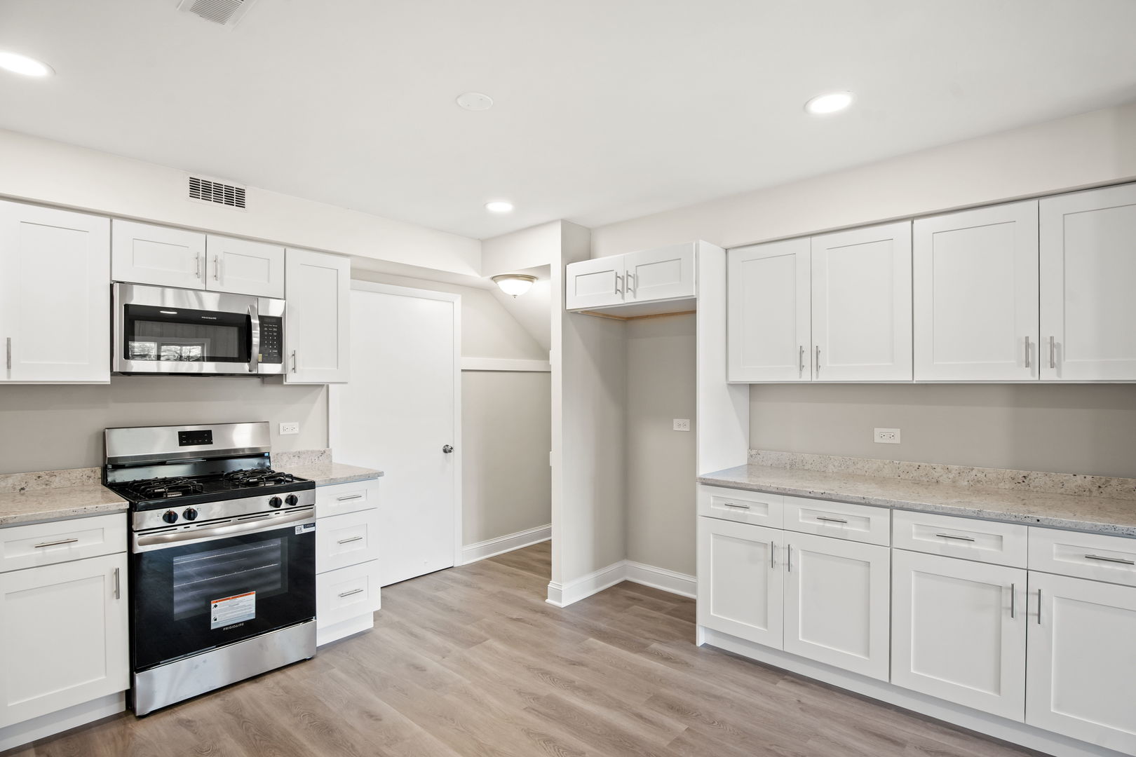 914 Brook Street Elgin, IL 60120 - Photo 14 of 21 a kitchen with granite countertop white cabinets and stainless steel appliances