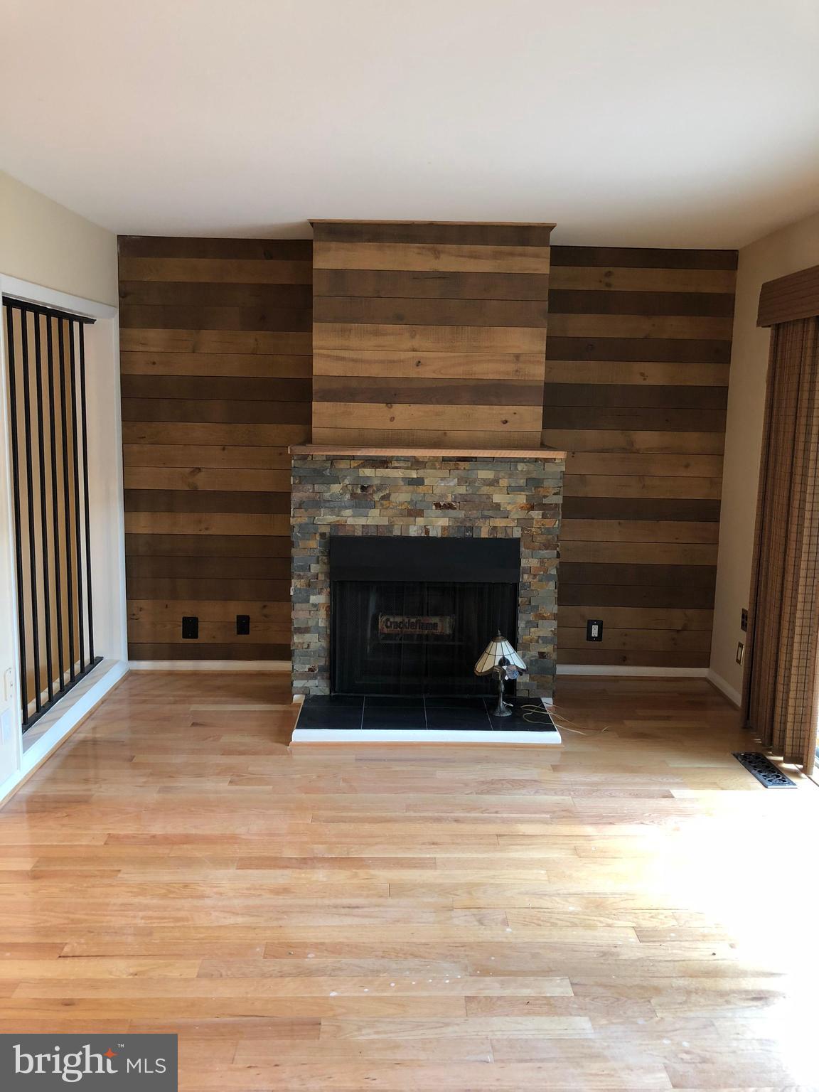 1634 Valencia Way Reston, VA 20190 - Photo 14 of 29 a view of an empty room with a fireplace and a window