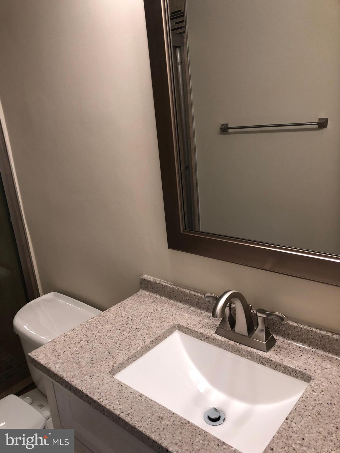 1634 Valencia Way Reston, VA 20190 - Photo 22 of 29 a bathroom with a granite countertop sink and a mirror