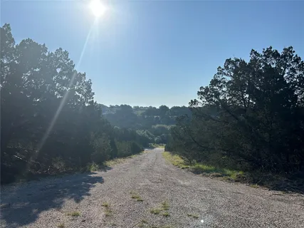 a view of a road with a mountain in the background