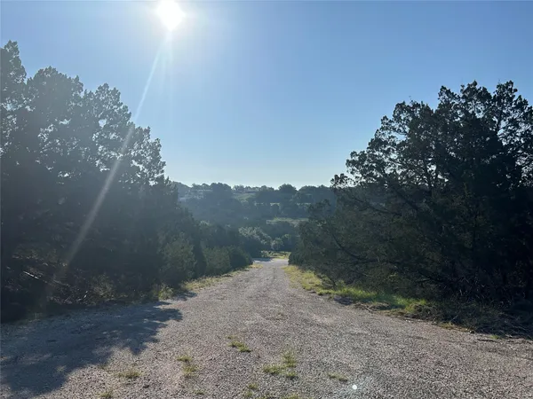 a view of a road with a mountain in the background