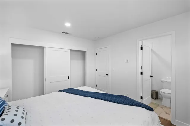 a bedroom with a bed and a bathroom