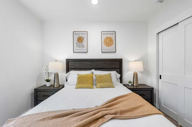 a bedroom with a bed and wall painting