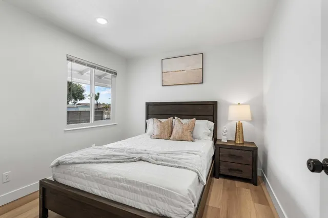 a bedroom with a bed and a window