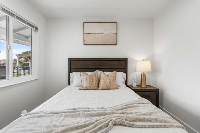 a bed room with a bed and a painting