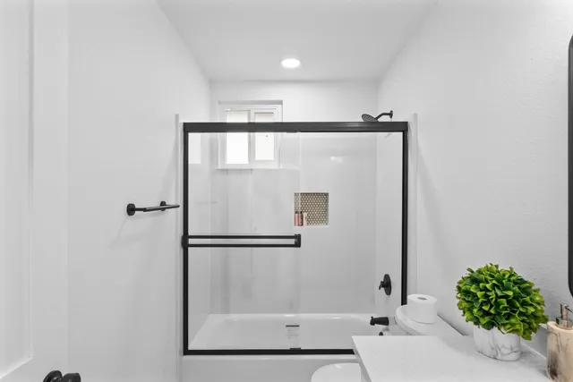a bathroom with a bathtub and a shower