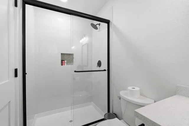 a bathroom with a shower and a toilet
