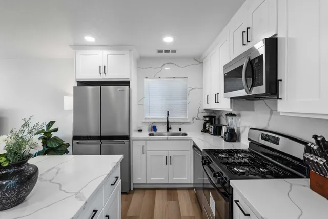 a kitchen with a sink stove and microwave