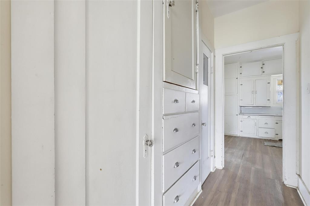 403 East Morgan Street Meridian, TX 76665 - Photo 23 of 40 wooden floor with white cabinets