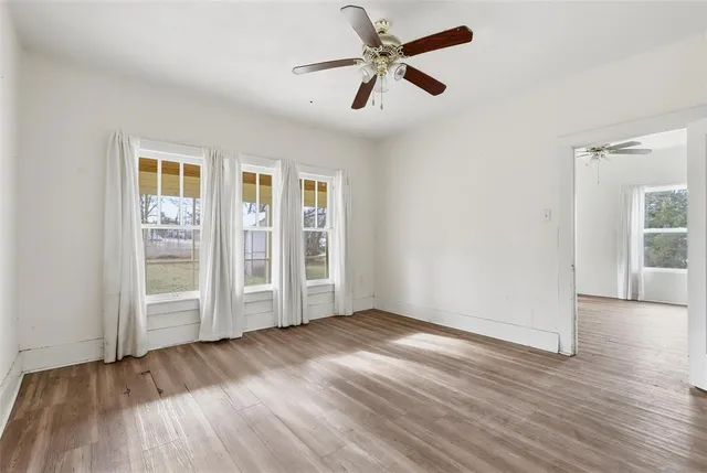 wooden floor in an empty room with a window