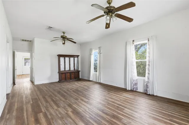 wooden floor in an empty room with a window