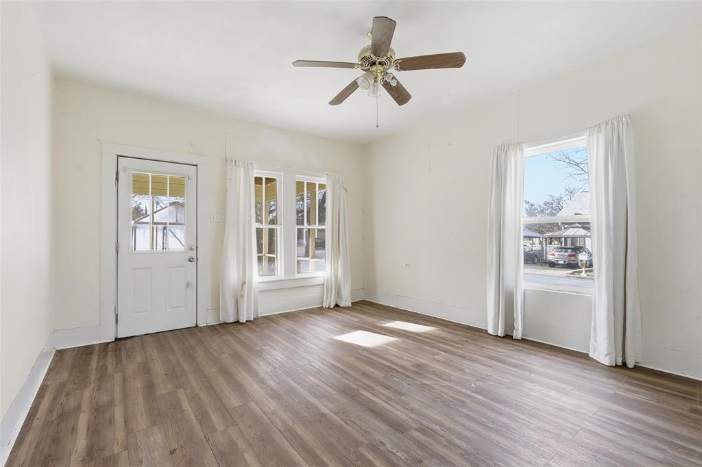 403 East Morgan Street Meridian, TX 76665 - Photo 34 of 40 a view of empty room with wooden floor and window