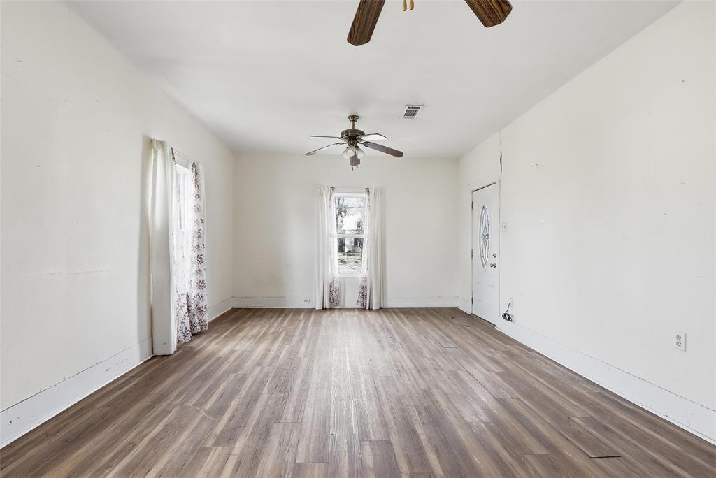 403 East Morgan Street Meridian, TX 76665 - Photo 36 of 40 wooden floor in an empty room with a window