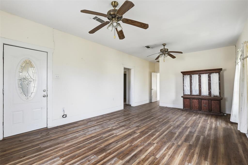 403 East Morgan Street Meridian, TX 76665 - Photo 38 of 40 wooden floor in an empty room with a window