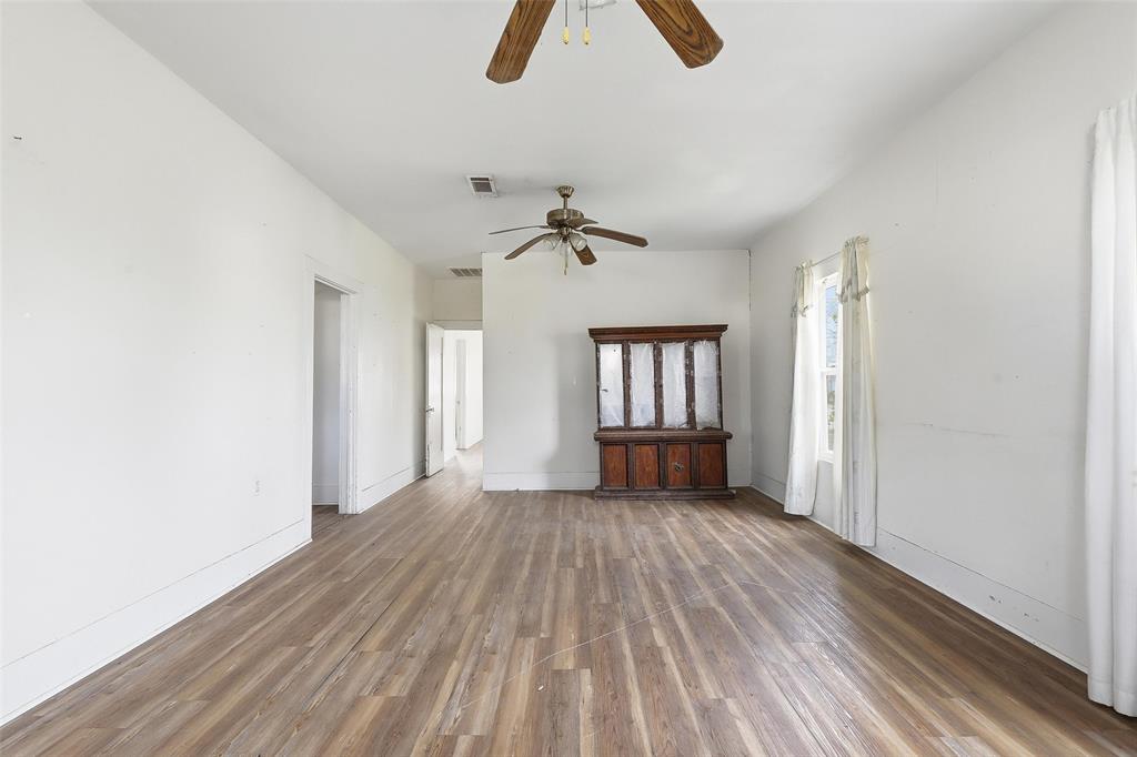 403 East Morgan Street Meridian, TX 76665 - Photo 39 of 40 wooden floor in an empty room with a window