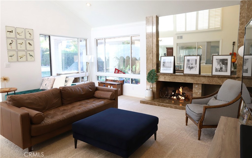 48 Cedar Tree Lane Irvine, CA 92612 - Photo 16 of 52 a living room with furniture and a fireplace