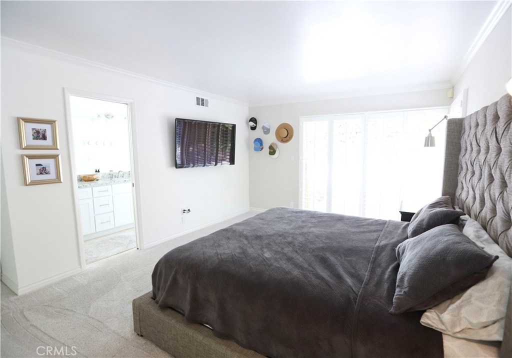 48 Cedar Tree Lane Irvine, CA 92612 - Photo 25 of 52 a bedroom with a bed and a flat screen tv