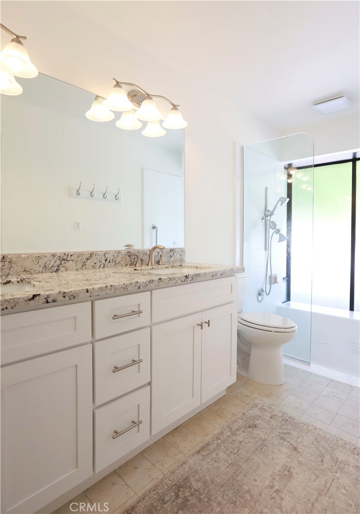 48 Cedar Tree Lane Irvine, CA 92612 - Photo 27 of 52 a spacious bathroom with a granite countertop sink a toilet and a mirror