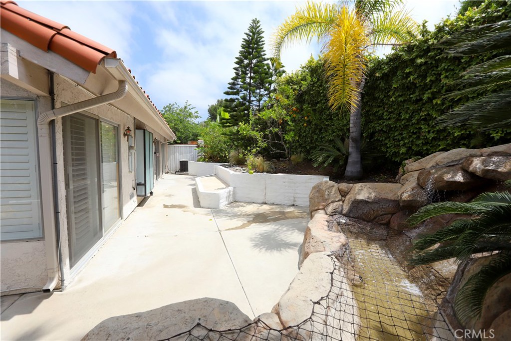 48 Cedar Tree Lane Irvine, CA 92612 - Photo 28 of 52 a view of a patio with couches and table and chairs under an umbrella
