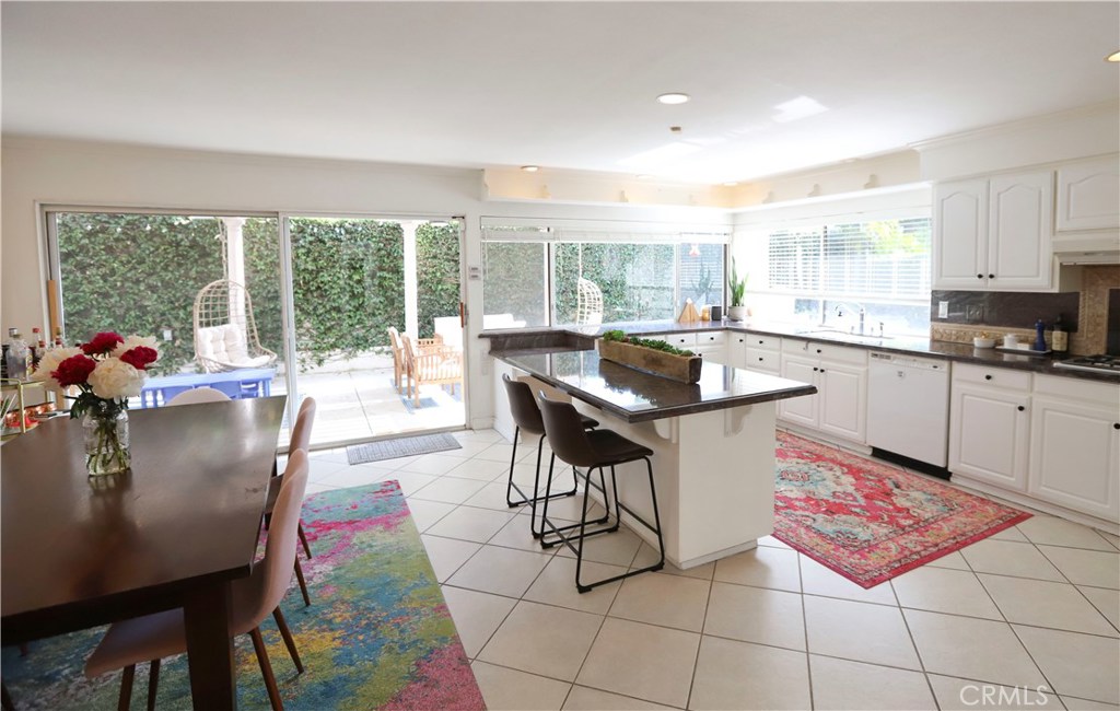 48 Cedar Tree Lane Irvine, CA 92612 - Photo 3 of 52 a kitchen with a dining table chairs and granite counter tops