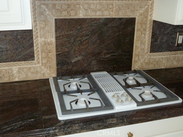 48 Cedar Tree Lane Irvine, CA 92612 - Photo 8 of 52 a black and white stove top oven sitting on a table