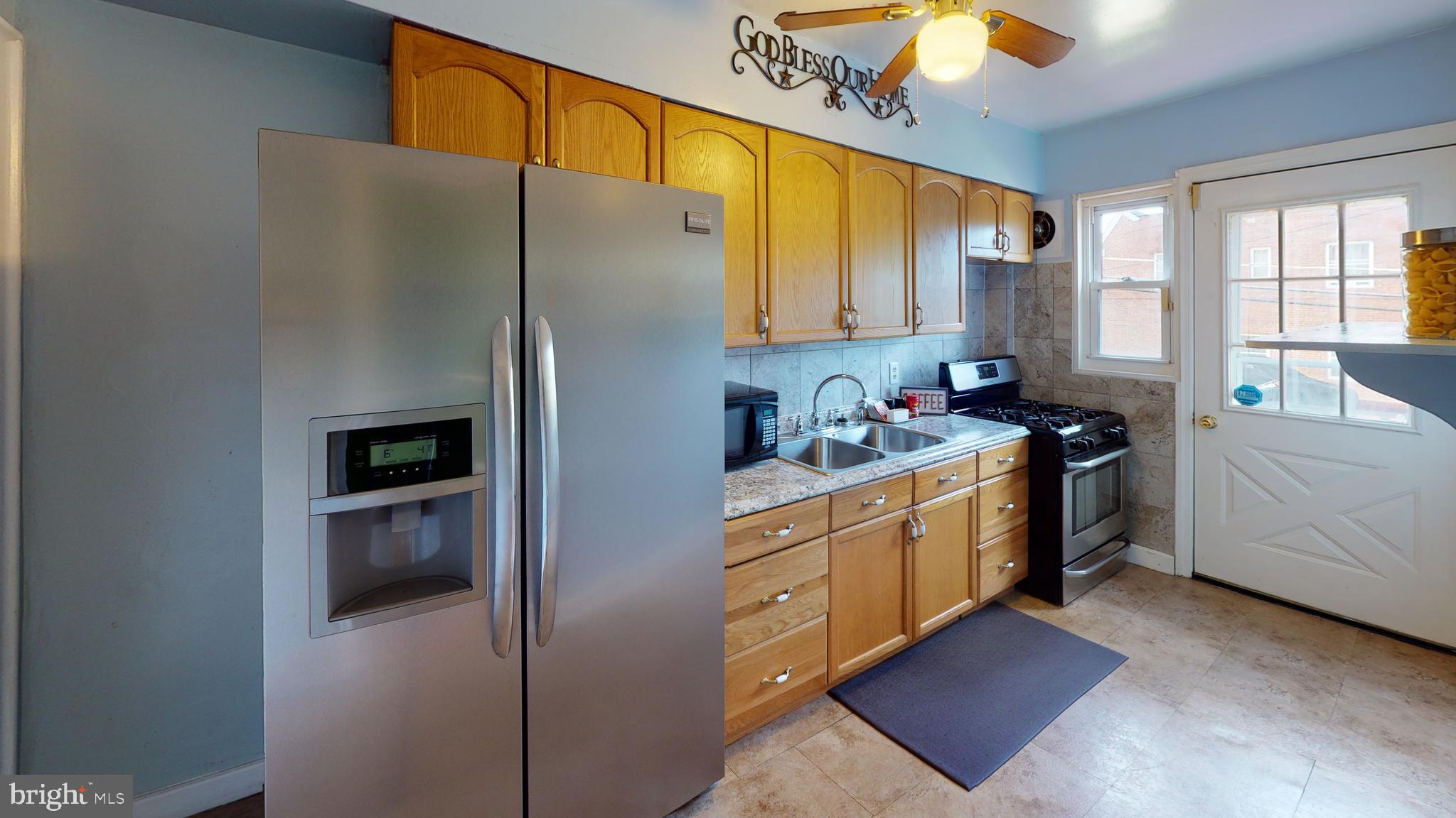 5438 Channing Road Baltimore, MD 21229 - Photo 4 of 20 a kitchen with stainless steel appliances a refrigerator sink and cabinets