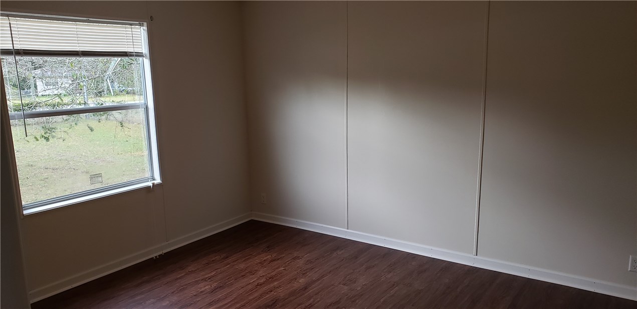 13465 Yellow Bluff Road Jacksonville, FL 32226 - Photo 14 of 30 an empty room with wooden floor and windows