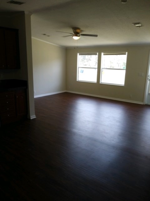 13465 Yellow Bluff Road Jacksonville, FL 32226 - Photo 7 of 30 a view of an empty room with wooden floor and a window