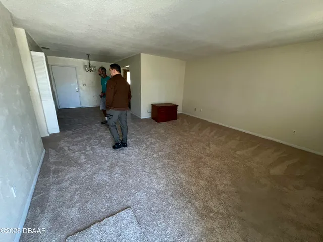 an empty room with wooden floor and entrance