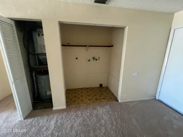 a view of an empty room and a window